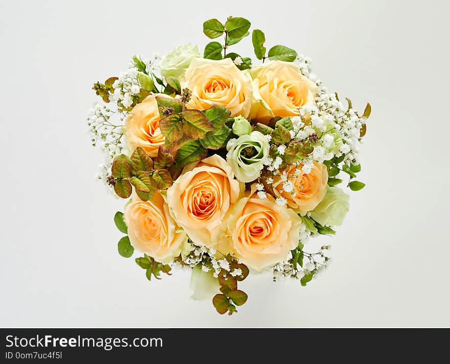 Beautiful wedding bouquet of roses, viewed in close-up from above on white background