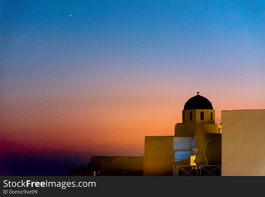 View of Oia village at the sunset - Aegean sea - Santorini island - Greece