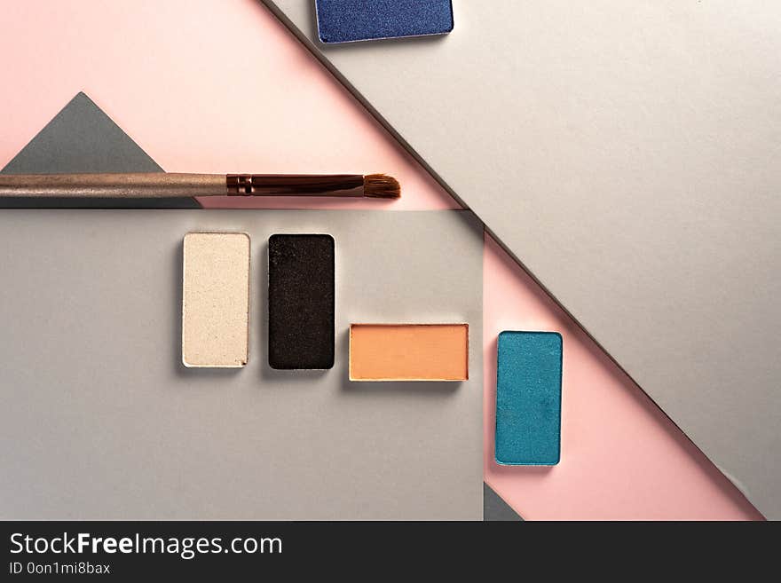 Elegant make up stills, on pastel geometric geometric background. from above. Elegant make up stills, on pastel geometric geometric background. from above