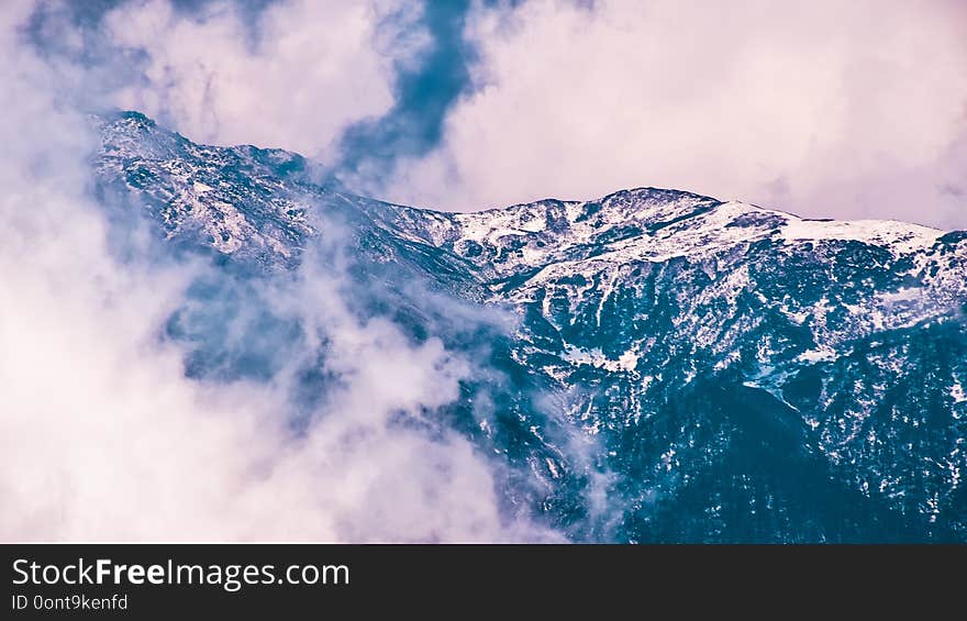 Kanchenjunga Mountain with scattered thick clouds at top. Beautiful landscape background photography. Yumthang Valley, North Sikkim