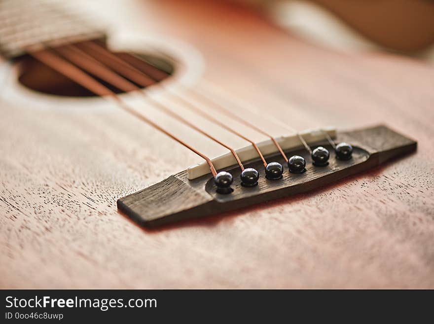 Sound adjusting. Close up detailed photo of guitar strings and sound hole.