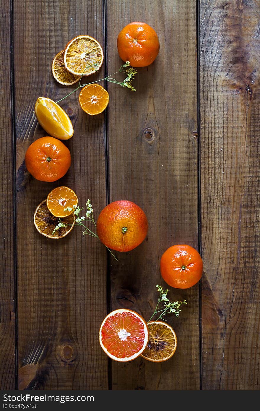 Ripe citrus fruits - oranges and tangerinnes, on rustic dark table