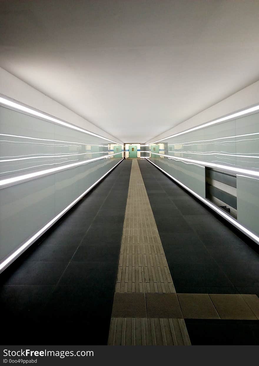 Modern pedastrians tunnel with linear white neon lights give a perspective vanishing point