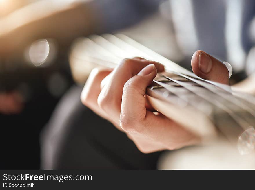 Guitar lessons. Close-up photo of male playing guitar. Creativity. Music lessons