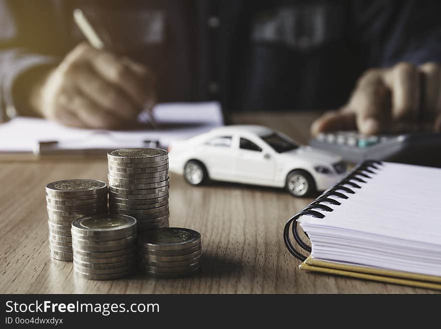 Car insurance and car service. Businessman and toy car for accounting and financial concept.