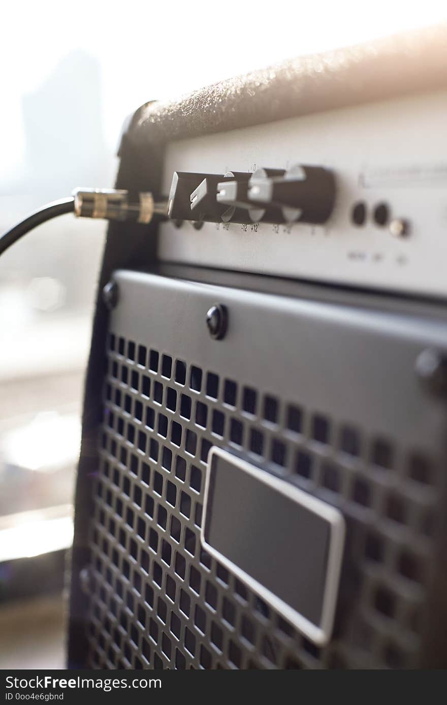 Choosing guitar amplifier. Vertical close-up view of guitar amplifier with cable audio jack. Musical instruments. Music equipment