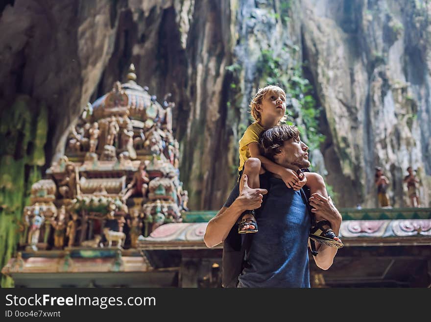 Father and son in the background of Batu Caves, near Kuala Lumpur, Malaysia. Traveling with children concept.