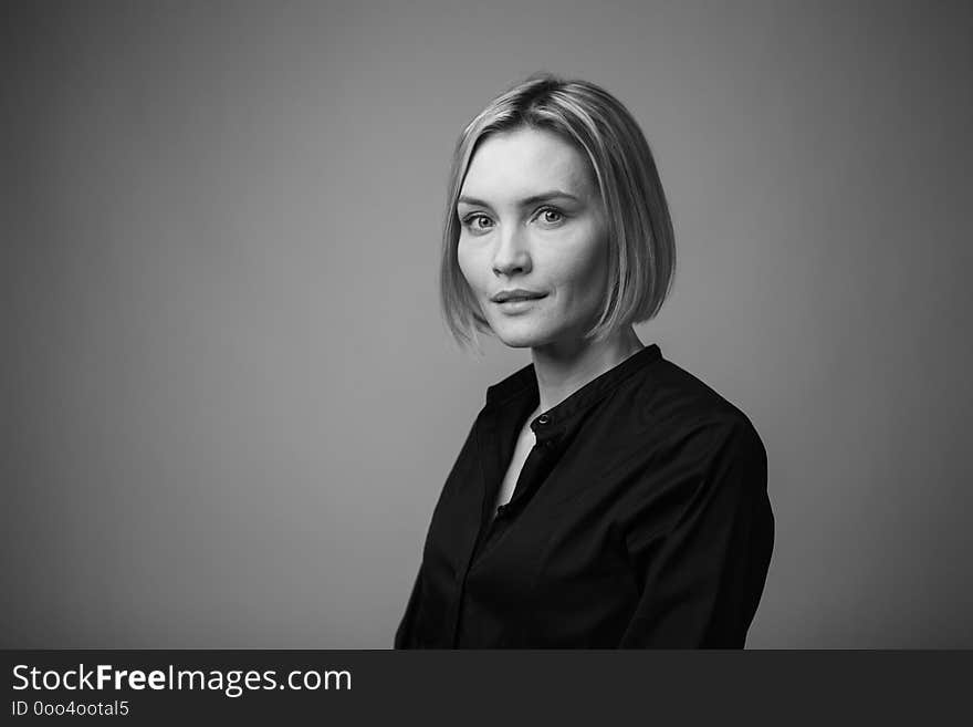 Dramatic black and white portrait of a beautiful woman on a dark background, studio shoot. Concept of natural beauty, no retouch.