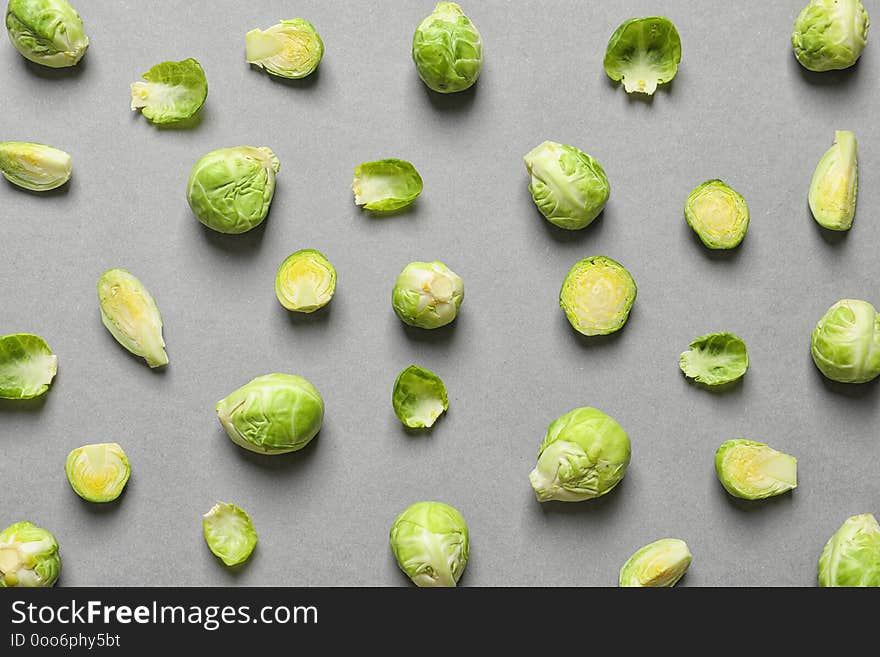 Tasty fresh Brussels sprouts on grey background, top view