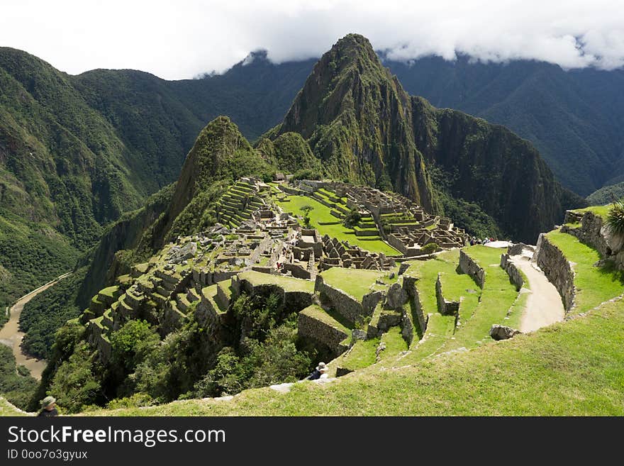 Machu Picchu and mount Huayna Picchu. View looking across the majority of the ruins. One of the seven wonders of the world. Unesco World Heritage Site. Machu Picchu and mount Huayna Picchu. View looking across the majority of the ruins. One of the seven wonders of the world. Unesco World Heritage Site.