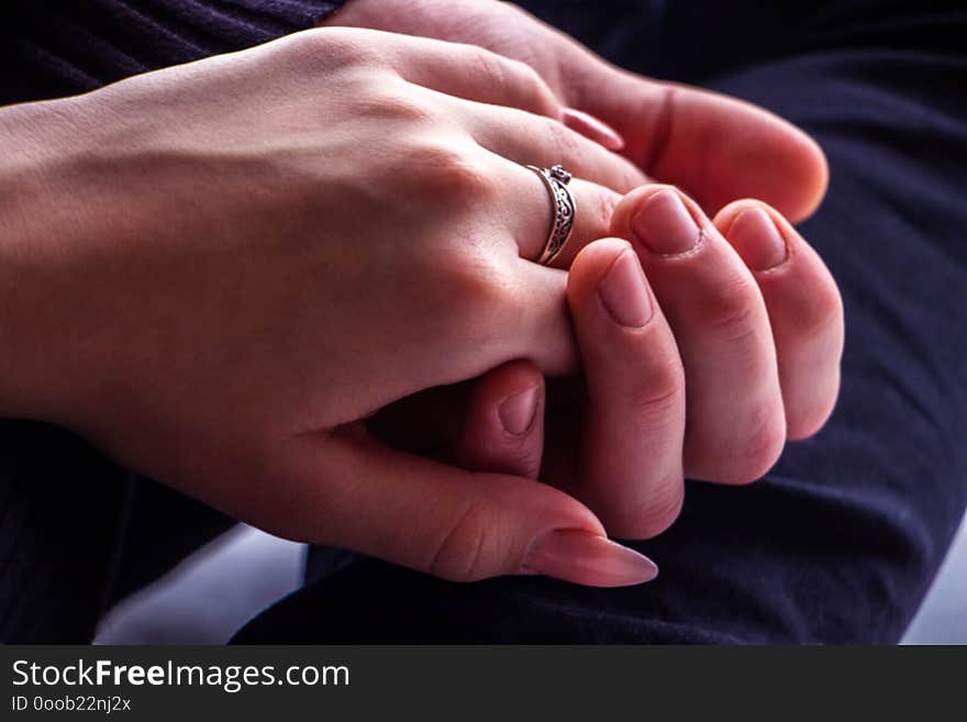 Girl`s hand, with a ring on his finger, in the hand of a guy close-up. Girl`s hand, with a ring on his finger, in the hand of a guy close-up