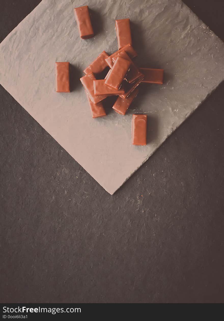 Sweet swiss chocolate candies on a stone tabletop, flatlay - desserts, confectionery and gluten-free organic food concept. All you need is chocolate