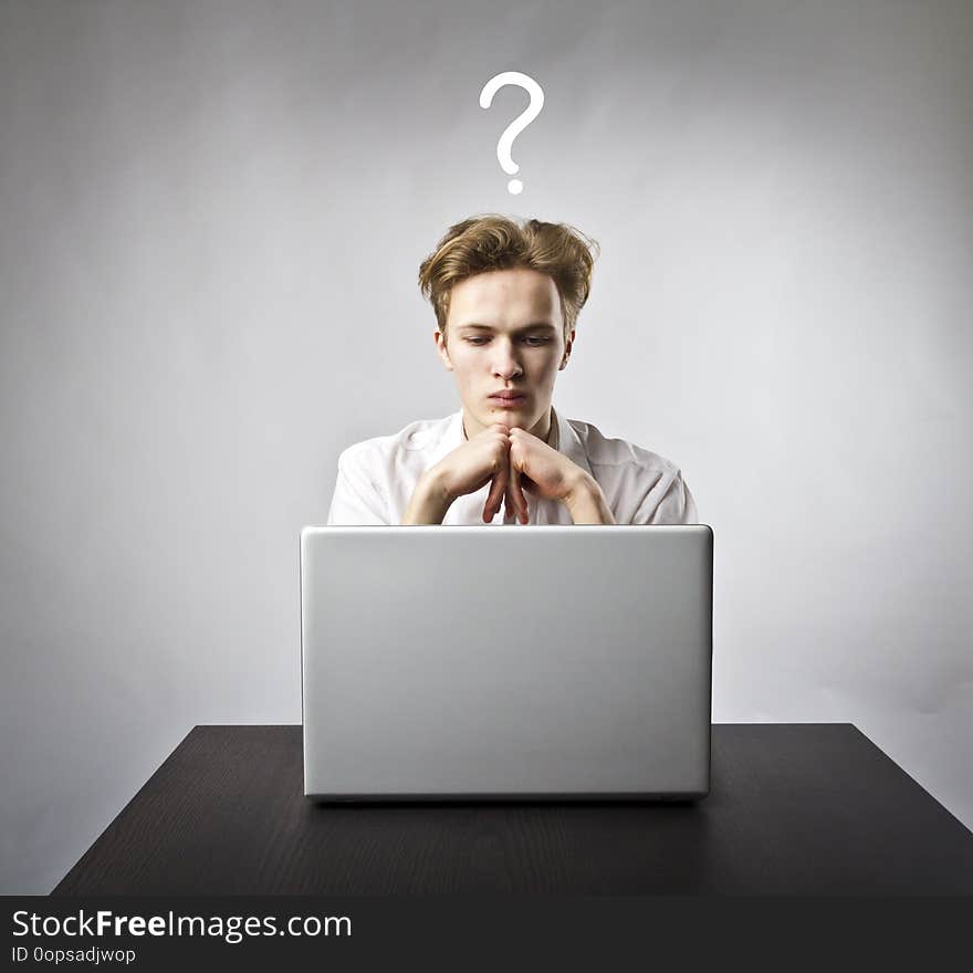 Young Man With Laptop. Question And Ignorance Concept