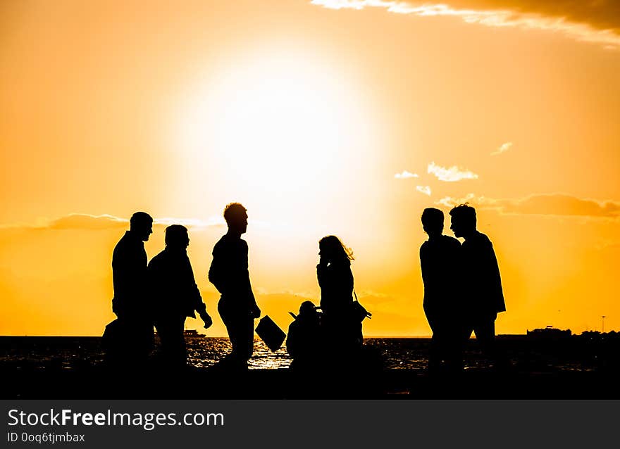 A group of people silhouette walking at the seaside at sunset in Alsancak, Izmir, Turkey