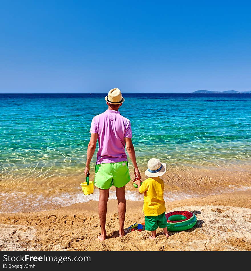 Toddler boy on beach with father