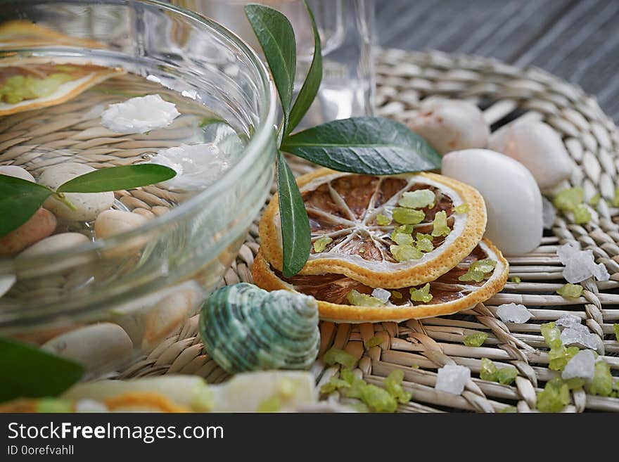 Composition of spa treatment with green salt and soap on wooden background. Spa concept