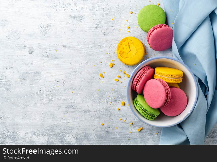 Colorful french macarons on concrete background