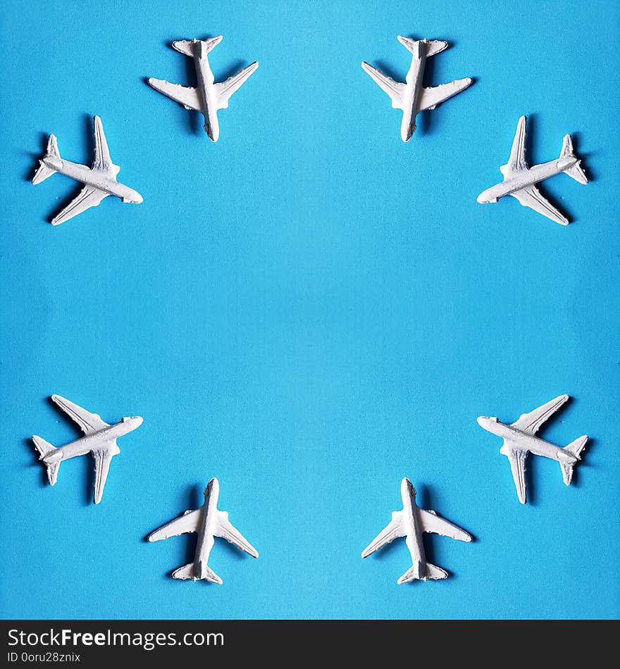 design of white plastic planes with blue background