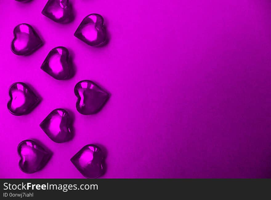 Texture violet hearts on a purple background