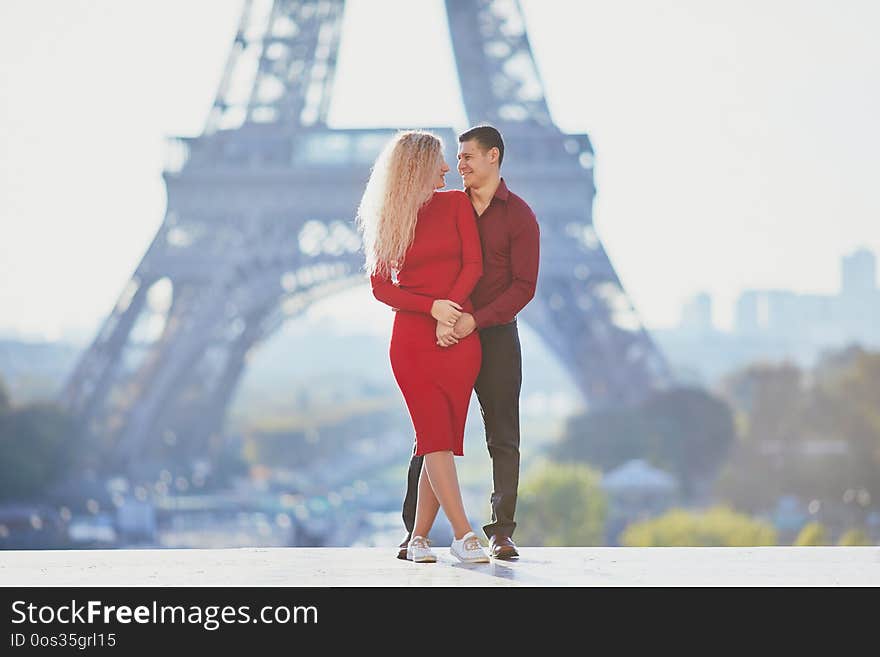 Romantic couple in love near the Eiffel tower in Paris, France