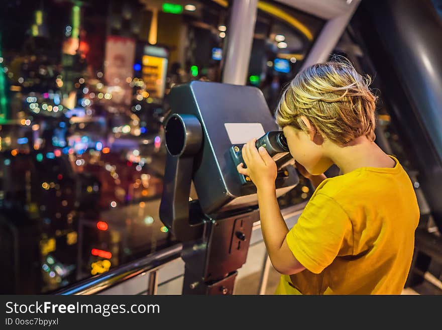 Little boy looks at Kuala lumpur cityscape. Panoramic view of Kuala Lumpur city skyline evening at sunset skyscrapers