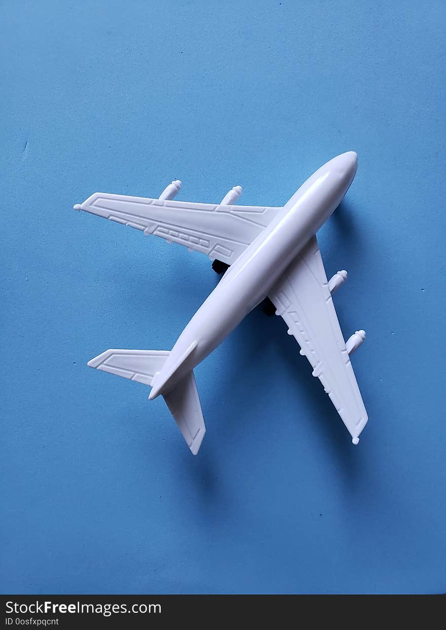 white plastic airplane and blue background