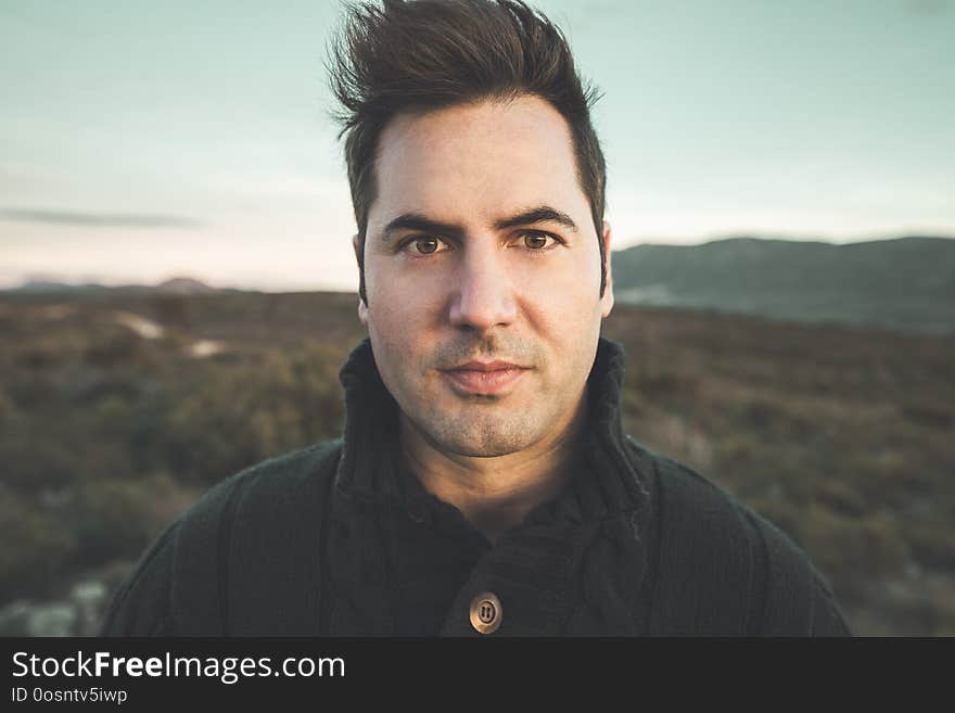 Portrait of a modern guy looking at the camera with happy expression outdoors. Photo style social networks and vintage. Portrait of a modern guy looking at the camera with happy expression outdoors. Photo style social networks and vintage