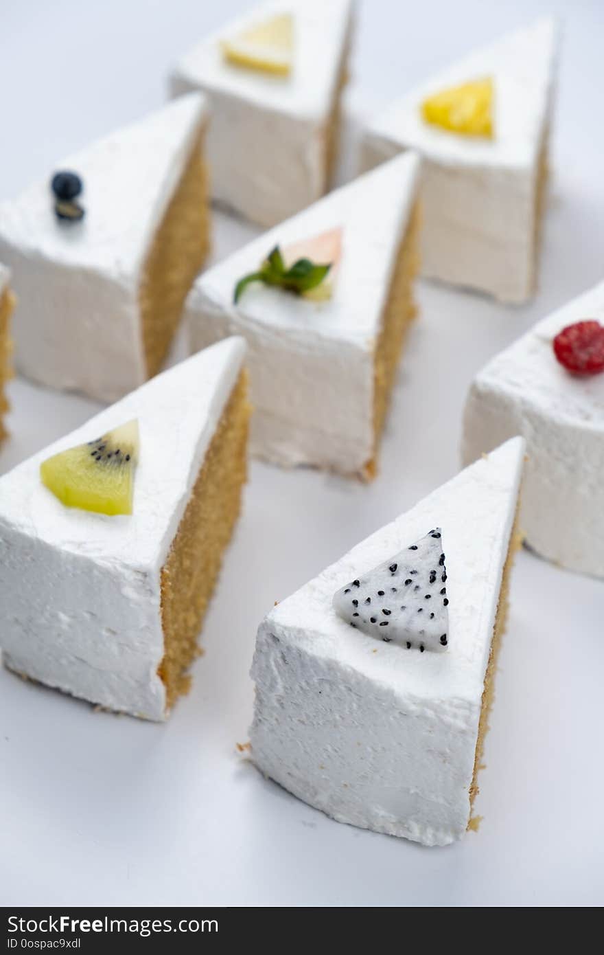 Delicious creamy minimal white cake with fruit on white background