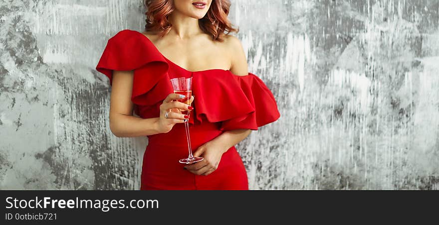 Smiling Woman In Red Dress With A Glass Of Champagne. Party Concept