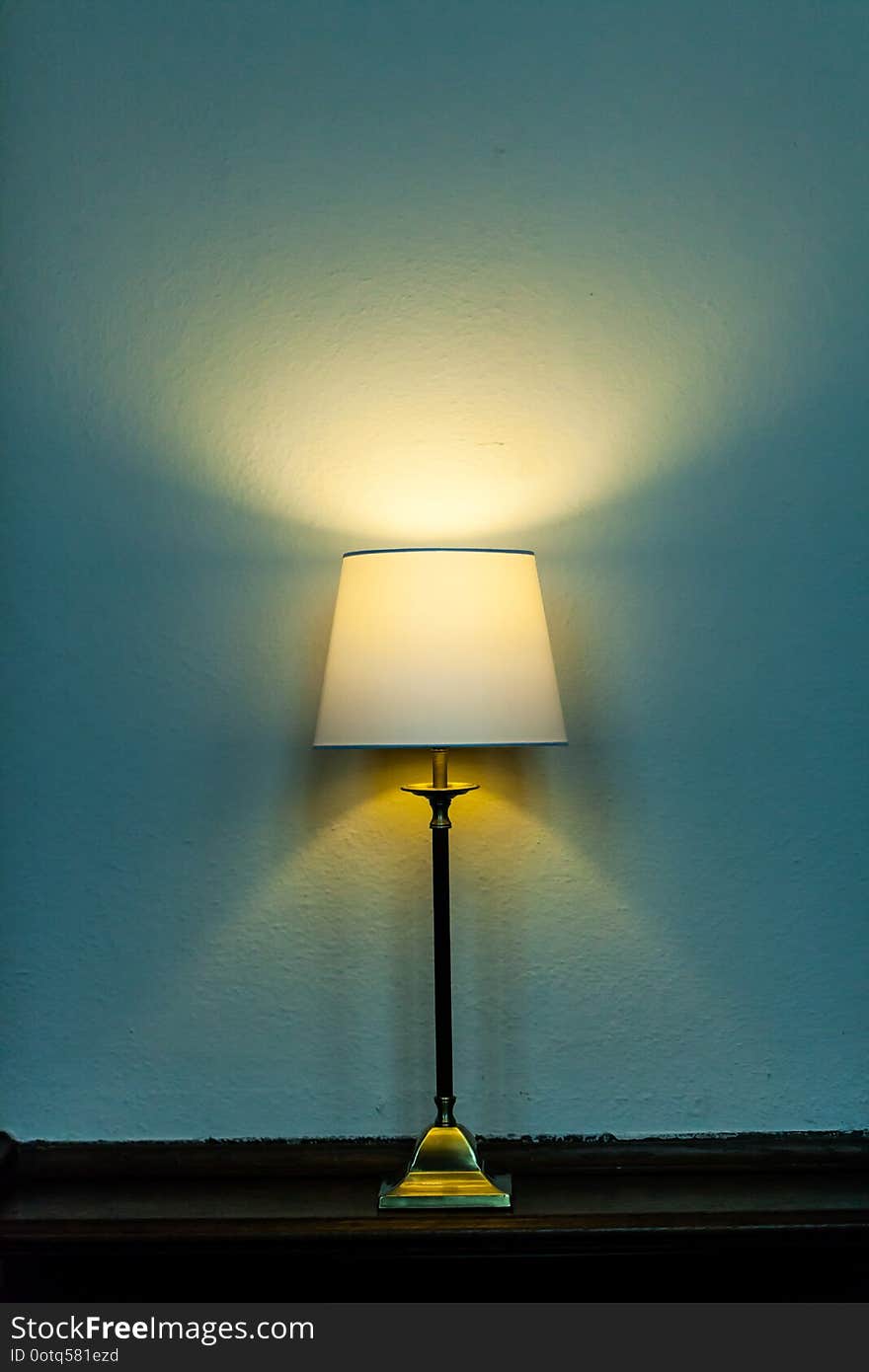 Night lamp standing on the table and lighting on the wall. Copy space with home concept.
