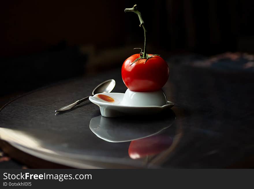 A bright red tomato on a branch hatched from an egg