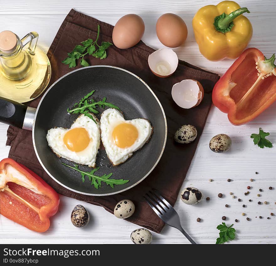 Fried eggs in the form of a heart in a skillet