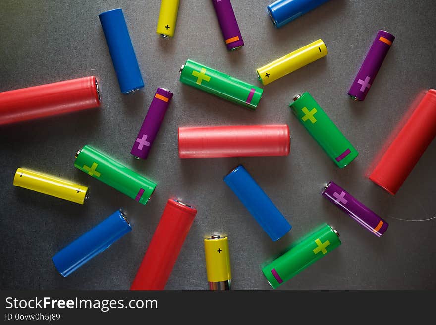 Many batteries on a metal table. Many batteries on a metal table