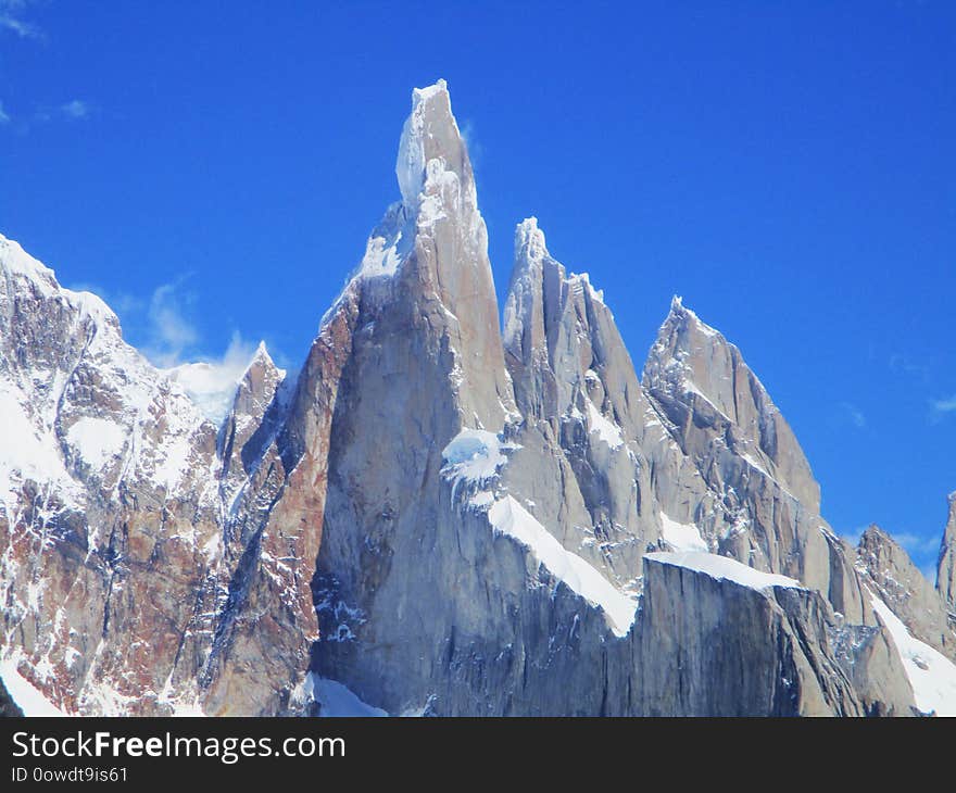 Cerro Torre is one of the mountains of the Southern Patagonian Ice Field in South America. It is located in a region which was disputed between Argentina and Chile, west of Fitz Roy also known as Cerro Chaltén. The peak is the highest of a four mountain chain: the other peaks are Torre Egger 2,685 m 8,809 ft, Punta Herron, and Cerro Standhardt. The top of the mountain often has a mushroom of rime ice, formed by the constant strong winds, increasing the difficulty of reaching the actual summit. Cerro Torre is one of the mountains of the Southern Patagonian Ice Field in South America. It is located in a region which was disputed between Argentina and Chile, west of Fitz Roy also known as Cerro Chaltén. The peak is the highest of a four mountain chain: the other peaks are Torre Egger 2,685 m 8,809 ft, Punta Herron, and Cerro Standhardt. The top of the mountain often has a mushroom of rime ice, formed by the constant strong winds, increasing the difficulty of reaching the actual summit.