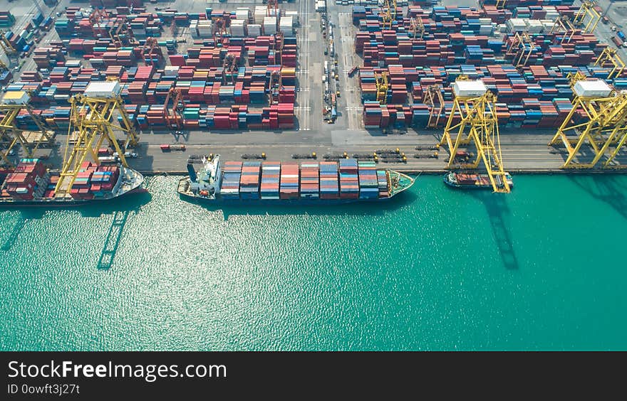 Container ship in export and import business and logistics. Shipping cargo to harbor by crane. Water transport International. Aerial view and top view