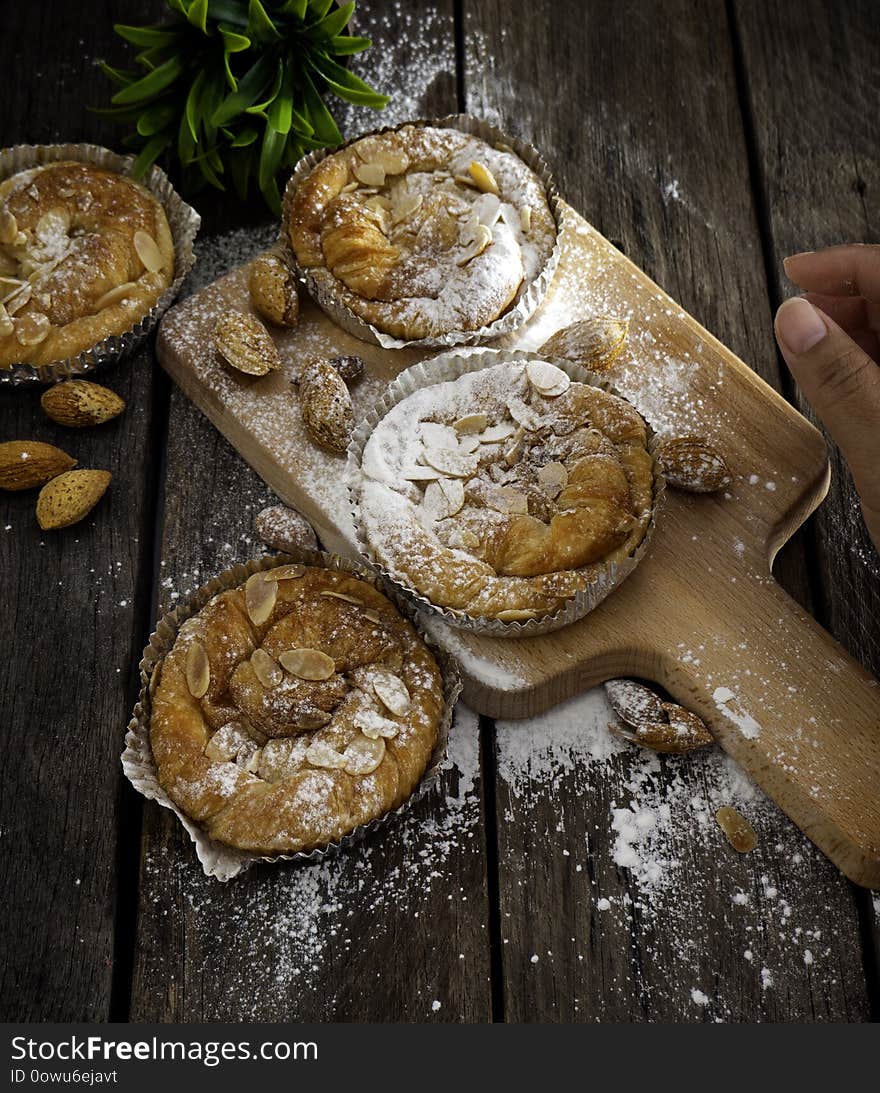 Loaf of Homemade Bread Lounge Almond Danish Pastry on wooden background with blank space