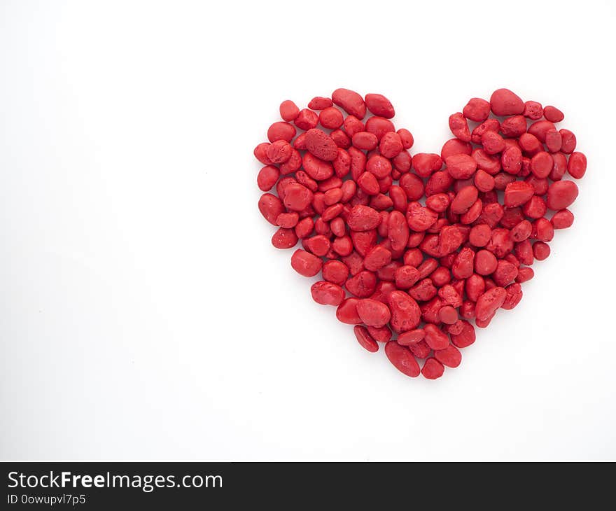 Creative love Small red stone is heart shape on white background