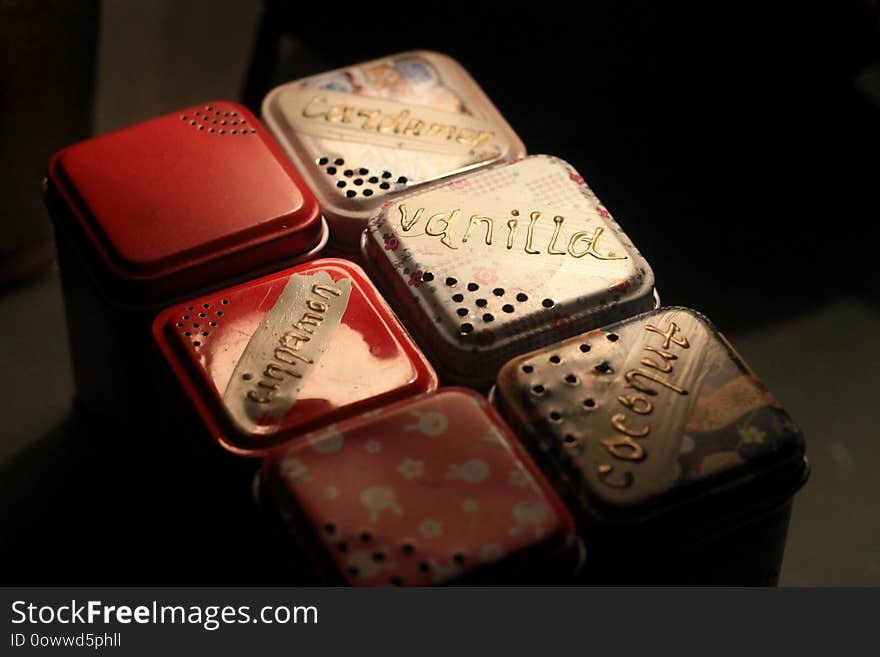 Multi-colored set of metal boxes with spices for home or cafe.