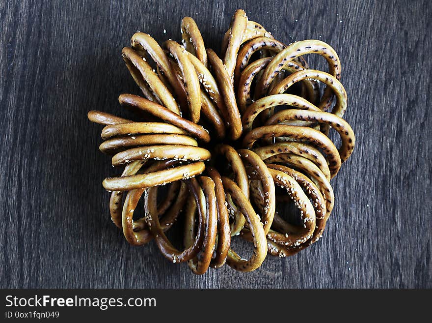 Bunch of bagels with sesame on wooden table