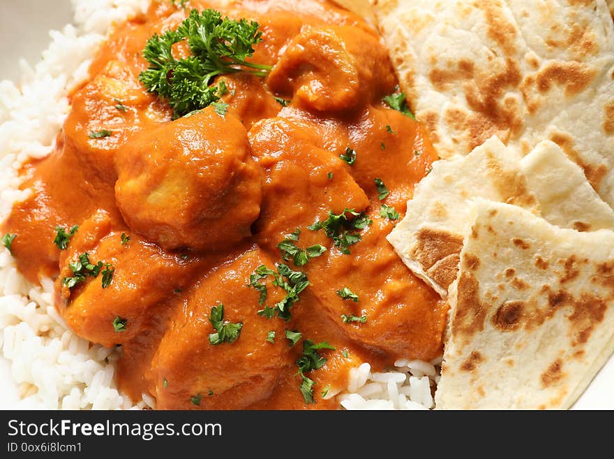 Delicious Butter Chicken With Rice And Naan As Background