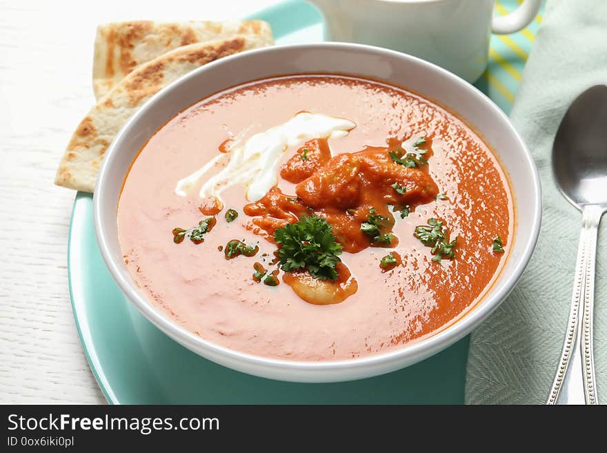 Delicious butter chicken in bowl served on table. Traditional Murgh Makhani dish