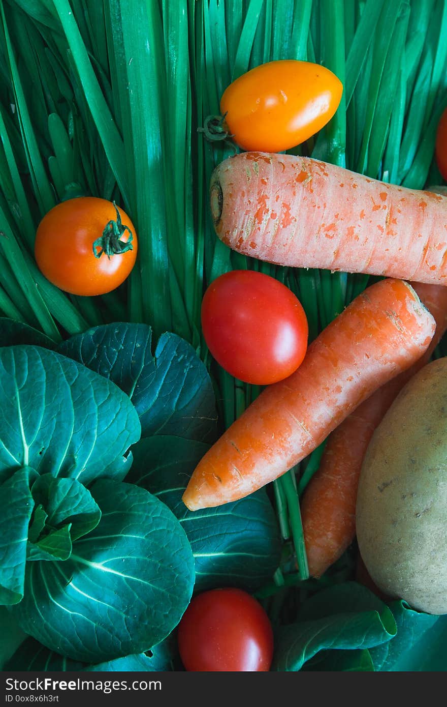 Vegan and vegetarian daily food. Vegetables in a box from organic farm delivery with carrots, tomatos, potatos, onion and Chinese chives.