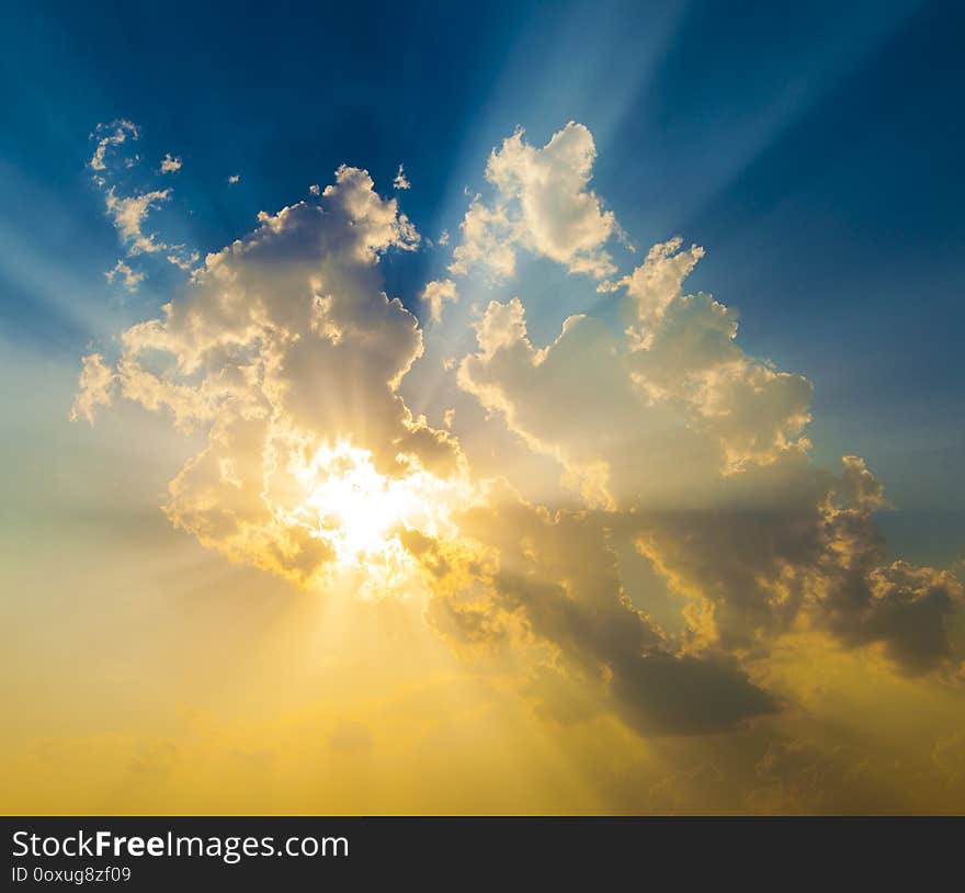 Spectacular sunset with sun rays and blue and orange sky