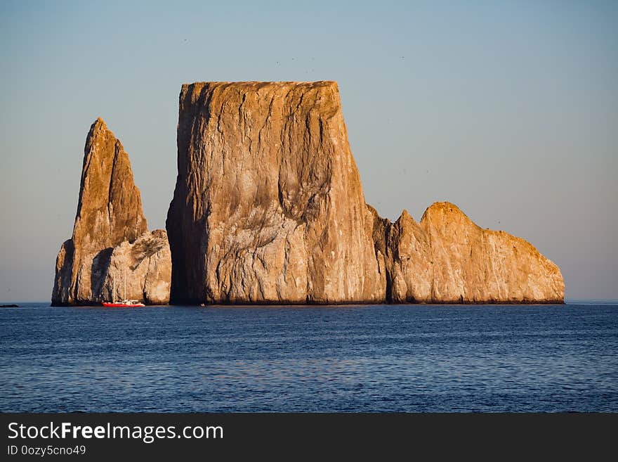 Birds fly around Kicker Islands of the Galapagos Islands