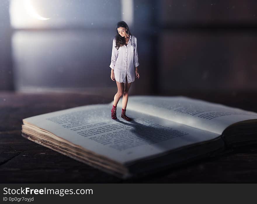 Good night concept with shrinked young woman reading book. Miniature unreal dreamy scene with moonlight