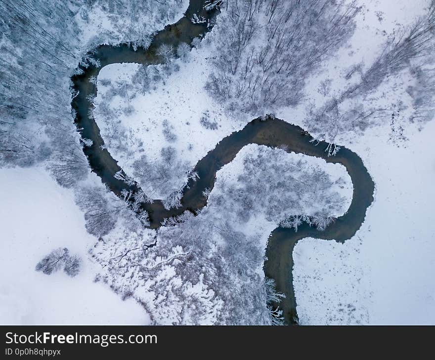 Aerial view of forest river in time of winter day. Aerial view of forest river in time of winter day.