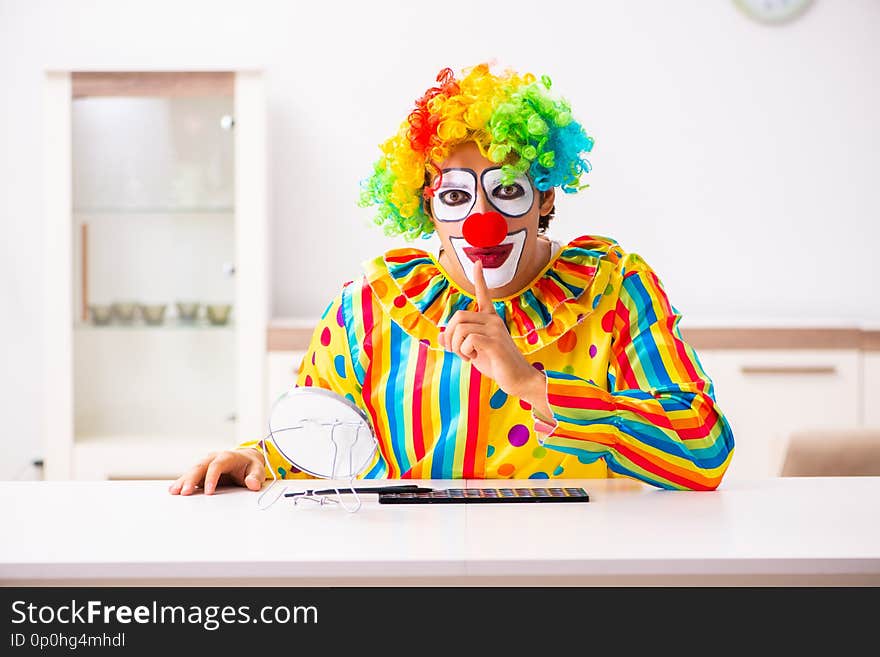 The male clown preparing for perfomance at home