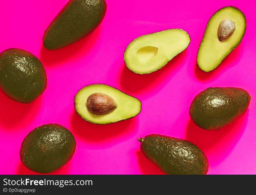 Fresh Avocado on Vibrant Pink background. Top view, flat lay. Banner