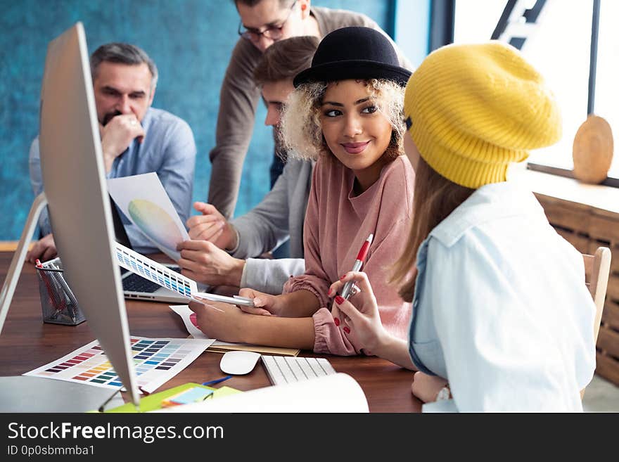 Successful team. Group of young business people working and communicating together in creative office.