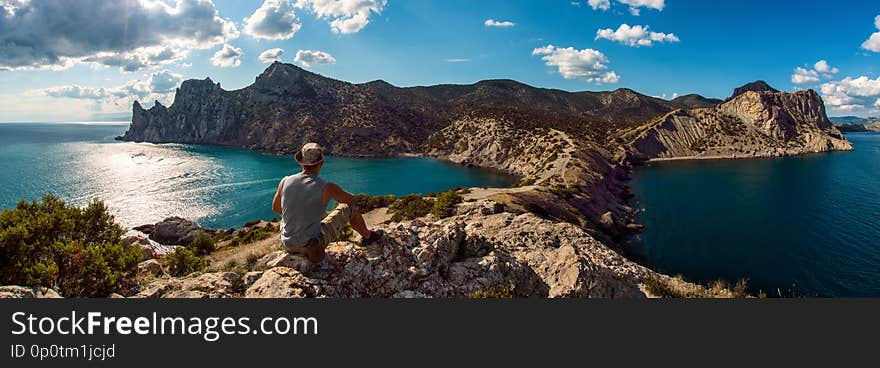 Hiker on beauty landscape Crimea  New World, Novy Svet background, travel and vacation concept, panoramic view. Hiker on beauty landscape Crimea  New World, Novy Svet background, travel and vacation concept, panoramic view